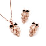 Wholesale wise owl jewelry set in rose gold plated zinc alloy featuring teardrop cat eye stone feathers owl pendant necklace and matching drop earrings from JuneJewelry.com.