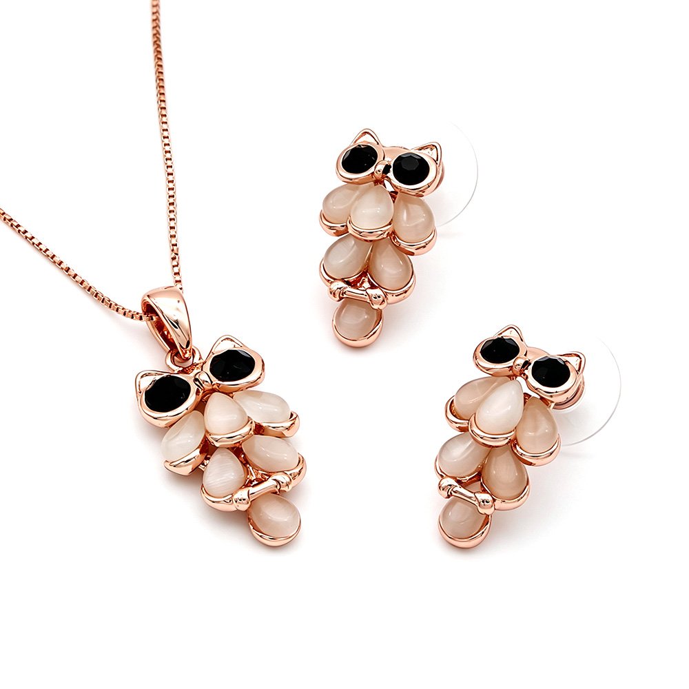 Wholesale wise owl jewelry set in rose gold plated zinc alloy featuring teardrop cat eye stone feathers owl pendant necklace and matching drop earrings from JuneJewelry.com.