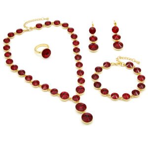 Wholesale ruby crystal jewelry set featuring round ruby red premium crystals, lariat drop necklace, drop earrings, tennis bracelet, and ring on 18K gold-plated copper from JuneJewelry.com.