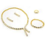 Wholesale crystal drop jewelry set featuring clear round premium crystals, lariat necklace, drop earrings, tennis bracelet, and ring on 18K gold-plated copper base from JuneJewelry.com.