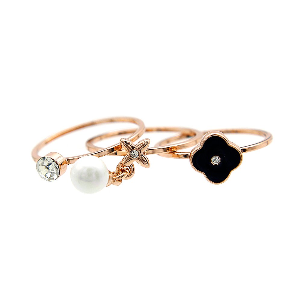 Wholesale pearl charm ring set in rose gold plated zinc alloy featuring four thin bands with a dangling pearl, crystal stud, star, and black clover charm from JuneJewelry.com.