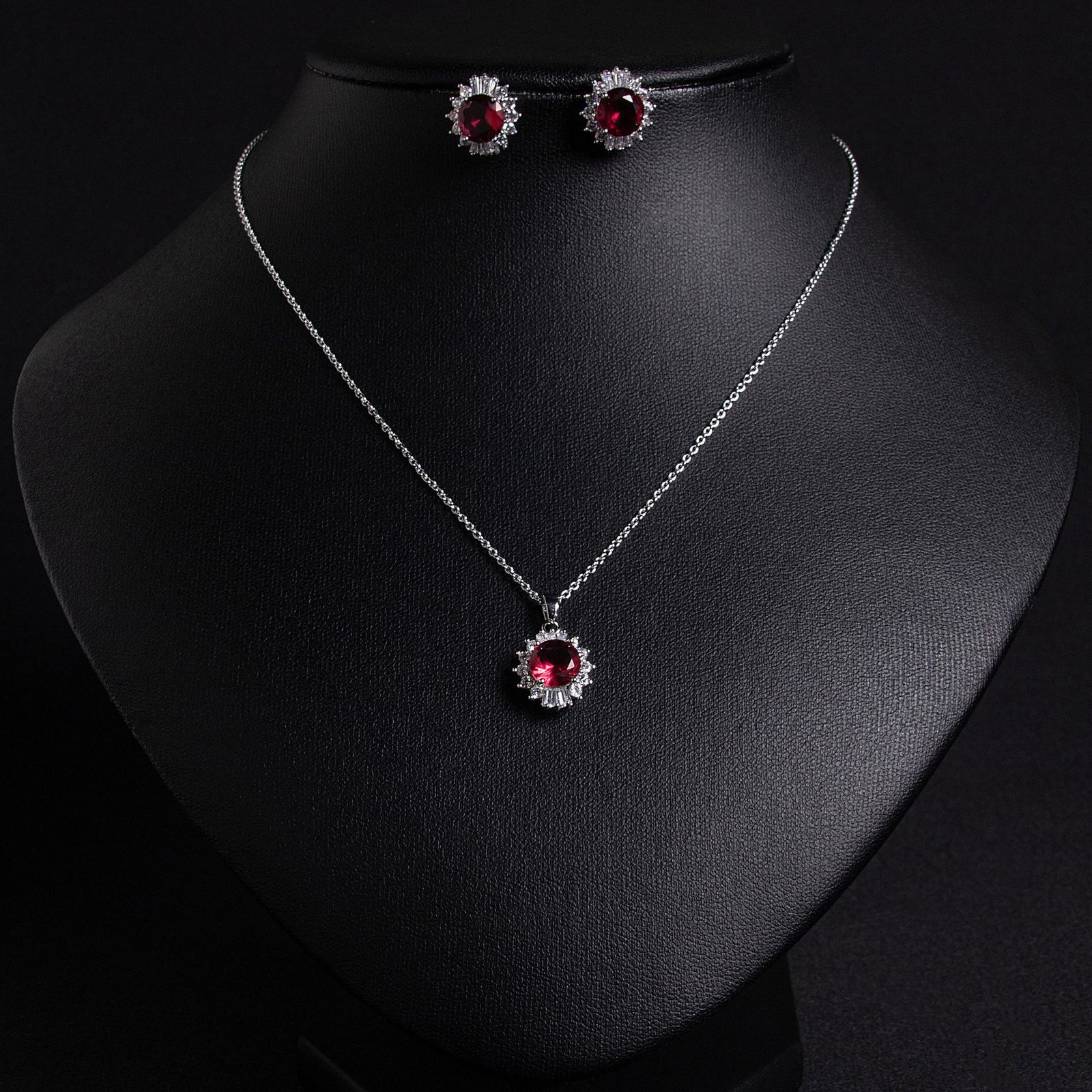 LJT29157 (5) Niche sunburst baguette zircon jewelry set wholesale featuring an oval gemstone surrounded by a sunburst halo of baguette and round cubic zirconia with matching stud earrings from junejewelry.com