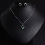 Niche sunburst baguette zircon jewelry set wholesale featuring an oval gemstone surrounded by a sunburst halo of baguette and round cubic zirconia with matching stud earrings from junejewelry.com