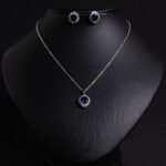 Niche sunburst baguette zircon jewelry set wholesale featuring an oval gemstone surrounded by a sunburst halo of baguette and round cubic zirconia with matching stud earrings from junejewelry.com