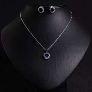 Niche sunburst baguette zircon jewelry set wholesale featuring an oval gemstone surrounded by a sunburst halo of baguette and round cubic zirconia with matching stud earrings from junejewelry.com