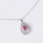 Niche layered teardrop jewelry set wholesale featuring a multi-layer hollow pave cubic zirconia teardrop pendant necklace with matching stud earrings from junejewelry.com