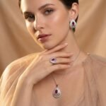 Niche layered teardrop jewelry set wholesale featuring a multi-layer hollow pave cubic zirconia teardrop pendant necklace with matching stud earrings from junejewelry.com