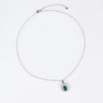 Niche emerald cut halo zircon jewelry set wholesale featuring an octagon emerald-cut gemstone surrounded by a baguette cubic zirconia halo with matching stud earrings from junejewelry.com