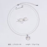 Niche textured pearl flower jewelry set wholesale featuring a lustrous central synthetic pearl nestled within textured, pave-set cubic zirconia flower petals with matching stud earrings from junejewelry.com