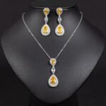 Niche double teardrop drop zircon jewelry set wholesale featuring a two-tier teardrop crystal pendant linked by marquise zircons with matching dangle earrings from junejewelry.com