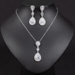 Niche double teardrop drop zircon jewelry set wholesale featuring a two-tier teardrop crystal pendant linked by marquise zircons with matching dangle earrings from junejewelry.com