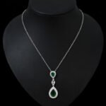 Niche double teardrop drop zircon jewelry set wholesale featuring a two-tier teardrop crystal pendant linked by marquise zircons with matching dangle earrings from junejewelry.com