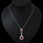 Niche double teardrop drop zircon jewelry set wholesale featuring a two-tier teardrop crystal pendant linked by marquise zircons with matching dangle earrings from junejewelry.com
