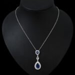 Niche double teardrop drop zircon jewelry set wholesale featuring a two-tier teardrop crystal pendant linked by marquise zircons with matching dangle earrings from junejewelry.com