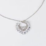 Niche hollow heart crystal jewelry set wholesale featuring an openwork marquise cubic zirconia heart wreath pendant necklace and matching heart earrings from junejewelry.com