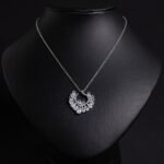 Niche hollow heart crystal jewelry set wholesale featuring an openwork marquise cubic zirconia heart wreath pendant necklace and matching heart earrings from junejewelry.com