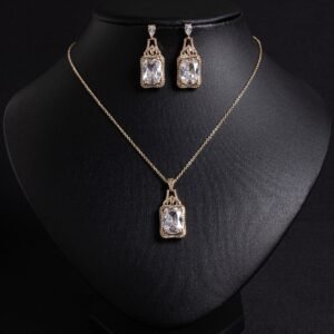 Niche emerald cut zircon halo jewelry set wholesale featuring a rectangular emerald-cut main gem inside an intricate pave cubic zirconia filigree frame with matching drop earrings from junejewelry.com