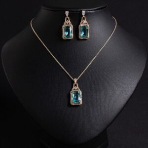 Niche emerald cut zircon halo jewelry set wholesale featuring a rectangular emerald-cut main gem inside an intricate pave cubic zirconia filigree frame with matching drop earrings from junejewelry.com