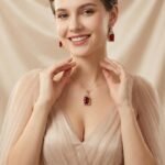 Niche emerald cut zircon halo jewelry set wholesale featuring a rectangular emerald-cut main gem inside an intricate pave cubic zirconia filigree frame with matching drop earrings from junejewelry.com