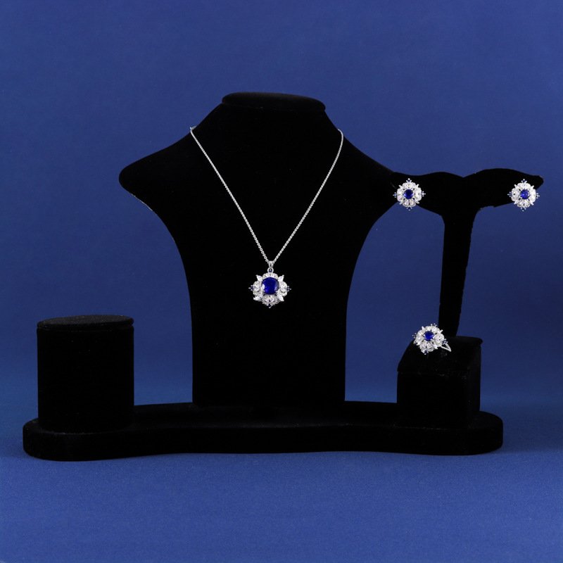 Niche snowflake crystal jewelry set wholesale featuring a central round gemstone surrounded by a cluster of marquise CZ crystals with matching stud earrings and ring from junejewelry.com