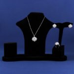 Niche snowflake crystal jewelry set wholesale featuring a central round gemstone surrounded by a cluster of marquise CZ crystals with matching stud earrings and ring from junejewelry.com