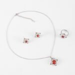 Niche snowflake crystal jewelry set wholesale featuring a central round gemstone surrounded by a cluster of marquise CZ crystals with matching stud earrings and ring from junejewelry.com