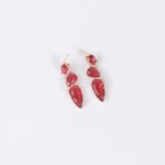 Niche cascading teardrop zircon jewelry set wholesale featuring a vertical geometric arrangement of gradient teardrop stones wrapped in a micro-pave wave with matching drop earrings from junejewelry.com