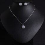 Niche square halo zircon jewelry set wholesale featuring a cushion-cut center gem enclosed by a pave cubic zirconia halo with matching stud earrings from junejewelry.com