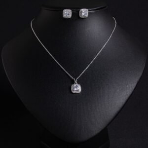 Niche square halo zircon jewelry set wholesale featuring a cushion-cut center gem enclosed by a pave cubic zirconia halo with matching stud earrings from junejewelry.com