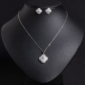 Niche four-leaf clover zircon jewelry set wholesale featuring a micro-pave cubic zirconia clover motif with a central pinwheel star icon and matching stud earrings from junejewelry.com