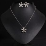 Niche five petal flower jewelry set wholesale featuring a delicate micro-pave CZ five petal blossom pendant necklace and matching flower stud earrings from junejewelry.com