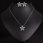Niche five petal flower jewelry set wholesale featuring a delicate micro-pave CZ five petal blossom pendant necklace and matching flower stud earrings from junejewelry.com