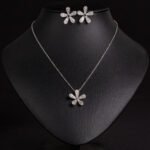 Niche five petal flower jewelry set wholesale featuring a delicate micro-pave CZ five petal blossom pendant necklace and matching flower stud earrings from junejewelry.com