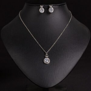 Niche crown zircon halo pendant necklace earring set wholesale featuring a micro-pave crown bail suspending a halo-set round crystal pendant with matching stud earrings from junejewelry.com