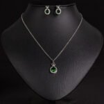 Niche crown zircon halo pendant necklace earring set wholesale featuring a micro-pave crown bail suspending a halo-set round crystal pendant with matching stud earrings from junejewelry.com