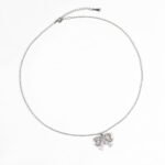 Niche bowknot crystal jewelry set wholesale featuring a sparkly baguette cubic zirconia ribbon bow pendant chain necklace and matching stud earrings from junejewelry.com