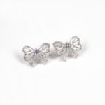 Niche bowknot crystal jewelry set wholesale featuring a sparkly baguette cubic zirconia ribbon bow pendant chain necklace and matching stud earrings from junejewelry.com