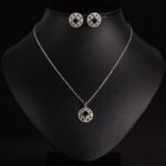 Niche circular starburst zircon jewelry set wholesale featuring a round openwork starburst pendant centered with a princess-cut crystal and matching stud earrings from junejewelry.com