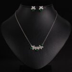 Niche triple flower crystal jewelry set wholesale featuring a curved garland of pave CZ flowers with teardrop crystal accents and matching floral stud earrings from junejewelry.com