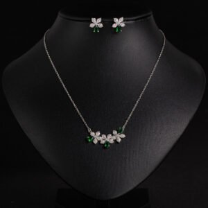 Niche triple flower crystal jewelry set wholesale featuring a curved garland of pave CZ flowers with teardrop crystal accents and matching floral stud earrings from junejewelry.com
