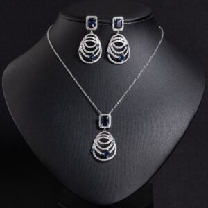 Niche concentric ring drop zircon jewelry set wholesale featuring an emerald-cut halo crystal suspended above tiered concentric pave rings with matching drop earrings from junejewelry.com
