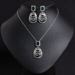 Niche concentric ring drop zircon jewelry set wholesale featuring an emerald-cut halo crystal suspended above tiered concentric pave rings with matching drop earrings from junejewelry.com