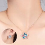 Niche five petal flower zircon jewelry set wholesale featuring a five-petal floral motif made of halo-framed pear cubic zirconia gems with matching stud earrings from junejewelry.com
