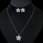 Niche five petal flower zircon jewelry set wholesale featuring a five-petal floral motif made of halo-framed pear cubic zirconia gems with matching stud earrings from junejewelry.com