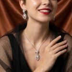 Niche pearl floral zircon jewelry set wholesale featuring a double-tiered synthetic pearl design framed with pave-set cubic zirconia leaf motifs and matching drop earrings from junejewelry.com