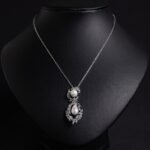 Niche pearl floral zircon jewelry set wholesale featuring a double-tiered synthetic pearl design framed with pave-set cubic zirconia leaf motifs and matching drop earrings from junejewelry.com