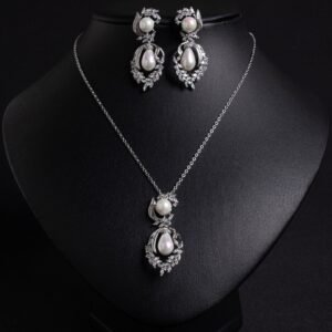 Niche pearl floral zircon jewelry set wholesale featuring a double-tiered synthetic pearl design framed with pave-set cubic zirconia leaf motifs and matching drop earrings from junejewelry.com