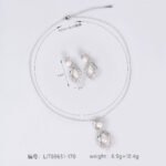 Niche pearl floral zircon jewelry set wholesale featuring a double-tiered synthetic pearl design framed with pave-set cubic zirconia leaf motifs and matching drop earrings from junejewelry.com