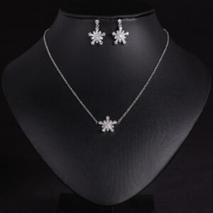 Niche snowflake zircon jewelry set wholesale featuring a delicate multi-point cubic zirconia snowflake pendant and matching drop earrings from junejewelry.com