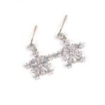 Niche snowflake zircon jewelry set wholesale featuring a delicate multi-point cubic zirconia snowflake pendant and matching drop earrings from junejewelry.com